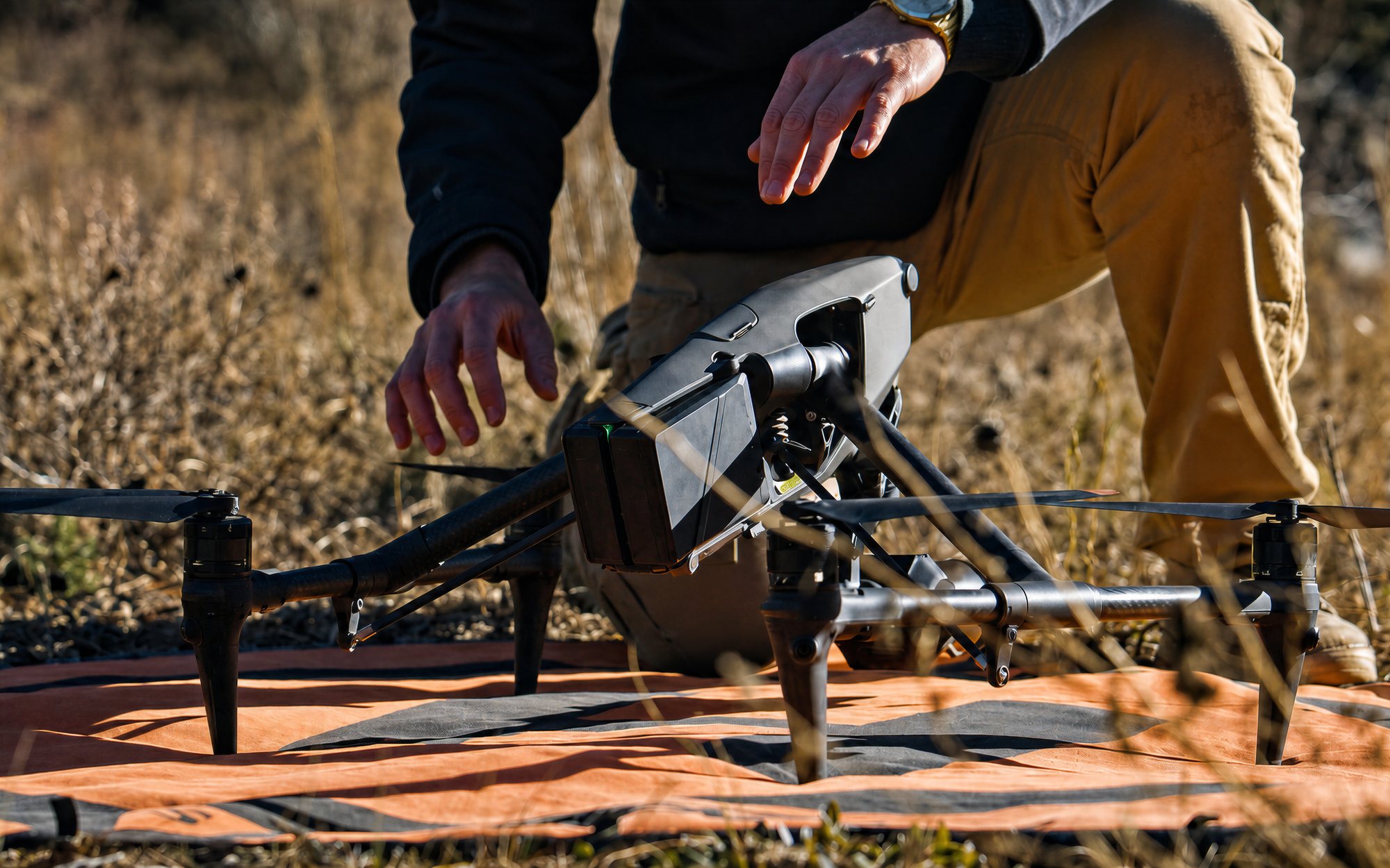 Pilot launching a DJI Inspire from a landing pad on location
